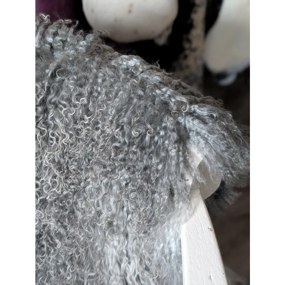 Grey curly fur teddy bear on 52x31 Gotland sheepskin by Oliver Luxury Sheepskins