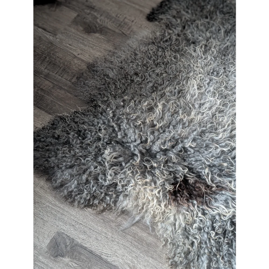 Grey fluffy Gotland sheepskin rug 52x31 on wooden floor
