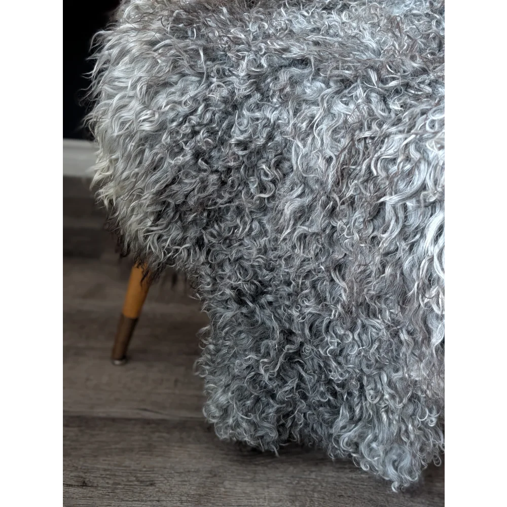 Gray Gotland sheepskin ottoman with wooden legs, 52x31