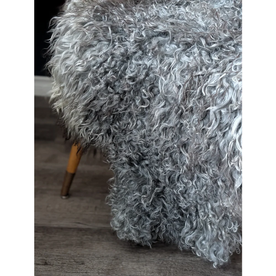 Gray Gotland sheepskin ottoman with wooden legs, 52x31