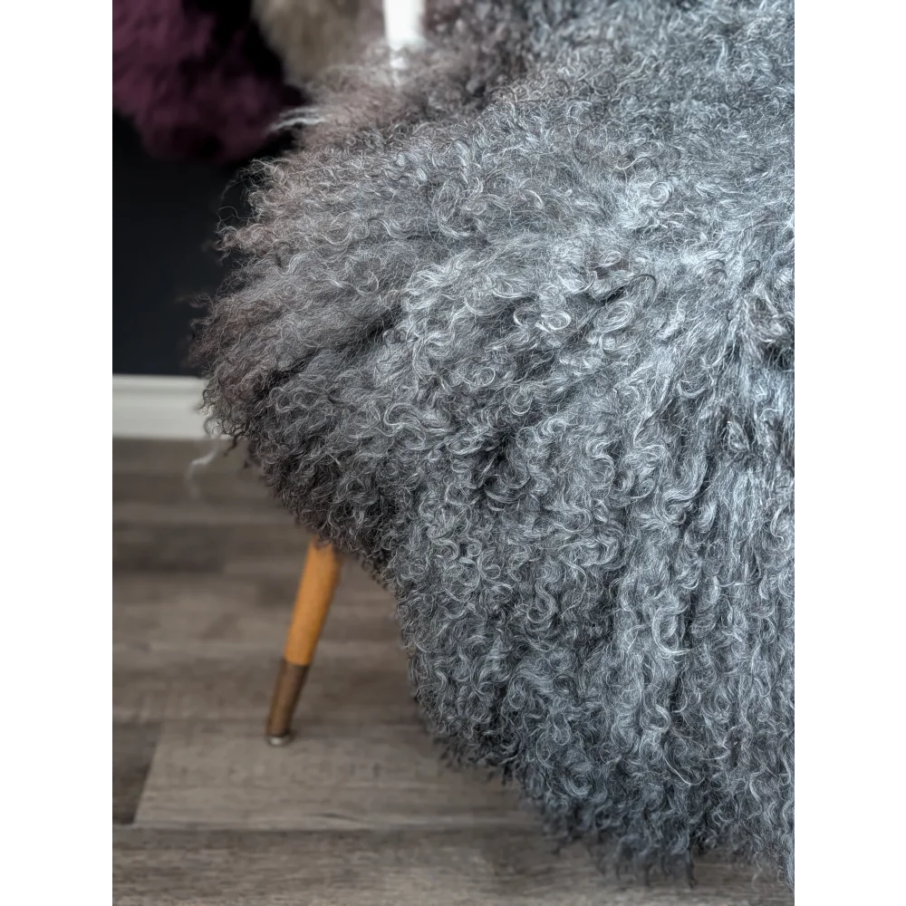 Gray fluffy armchair with wooden legs on Oliver Luxury Sheepskins Gotland 52x31