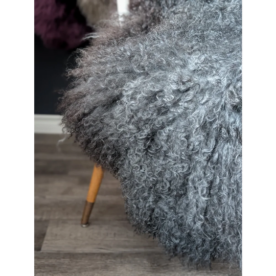 Gray fluffy armchair with wooden legs on Oliver Luxury Sheepskins Gotland 52x31