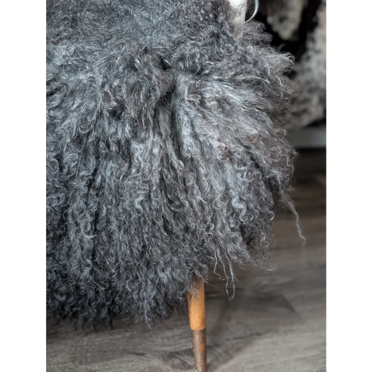 Gotland sheepskin 52x31 throw pillow with wooden legs and curved handle