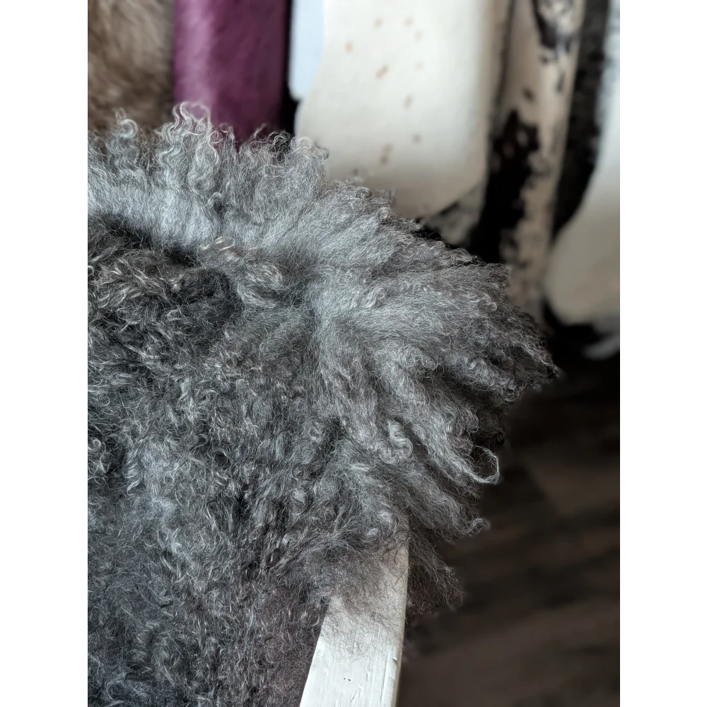 Cute silver poodle toy on Oliver Luxury Sheepskins Gotland sheepskin 52x31