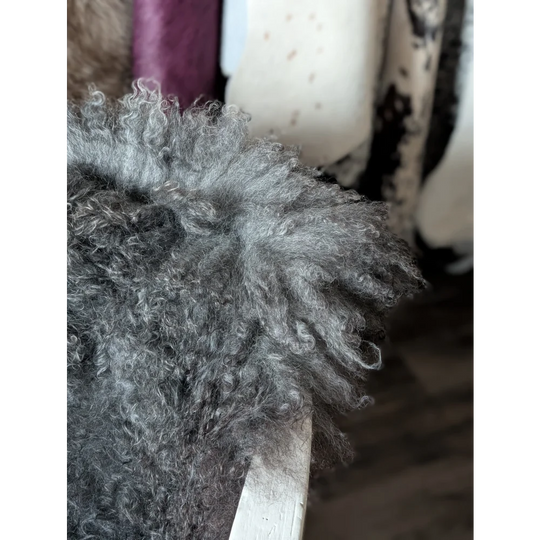 Cute silver poodle toy on Oliver Luxury Sheepskins Gotland sheepskin 52x31