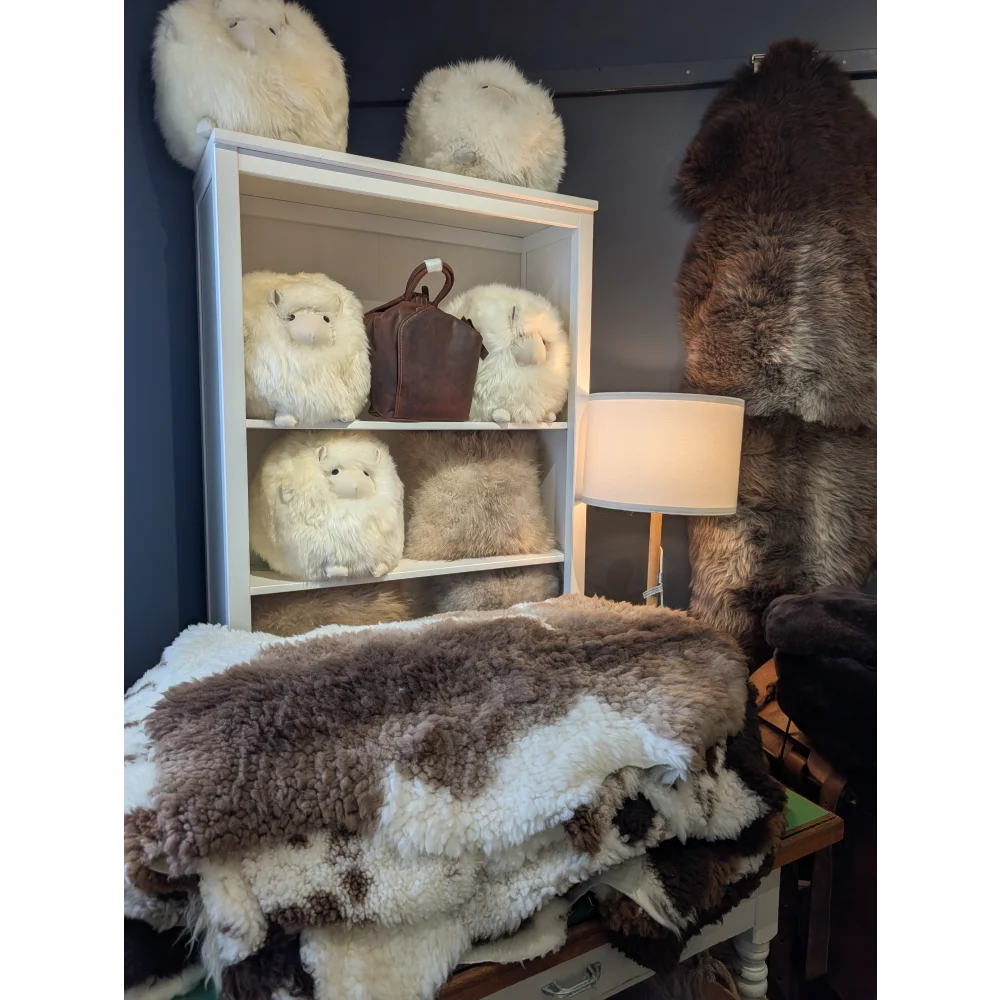 A cream-colored alpaca plush pillow with soft fluffy fur featured in grade b- sheepskins by angus oliver canada