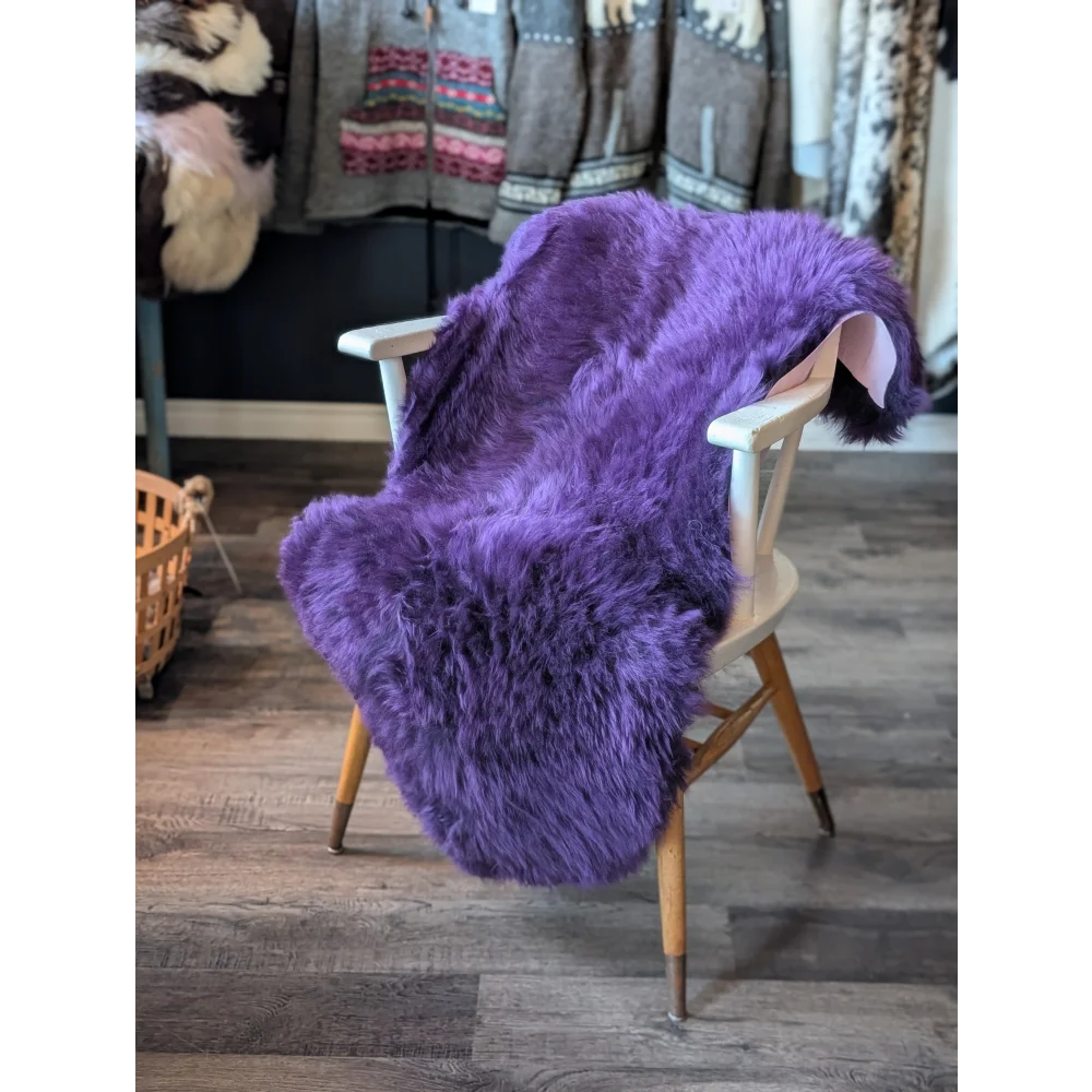 Gorgeous grape purple merino sheepskin on lavender faux fur chair