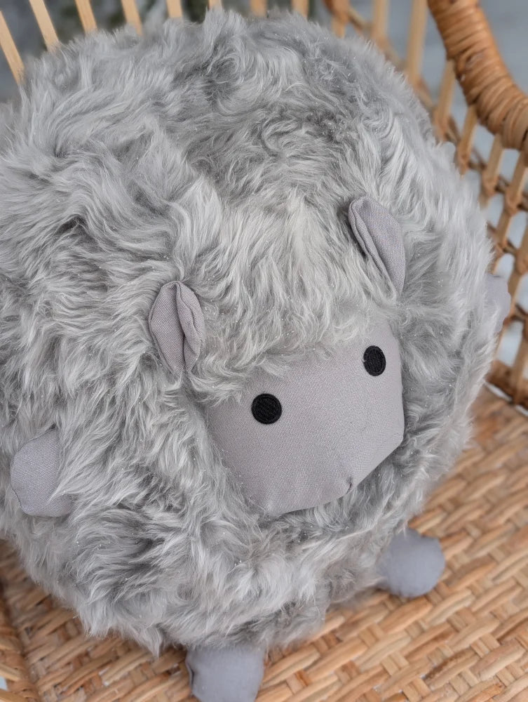 Grey rotund sheep cushion made of soft fluffy merino sheepskin with simple black button eyes by angus oliver