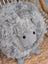 Grey rotund sheep cushion made of soft fluffy merino sheepskin with simple black button eyes by angus oliver