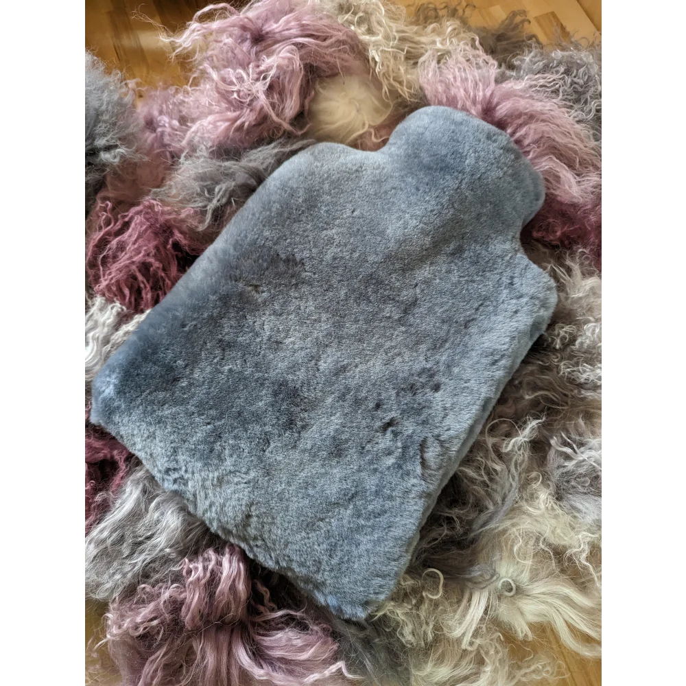 Blue plush hot water bottle with fuzzy sheepskin texture