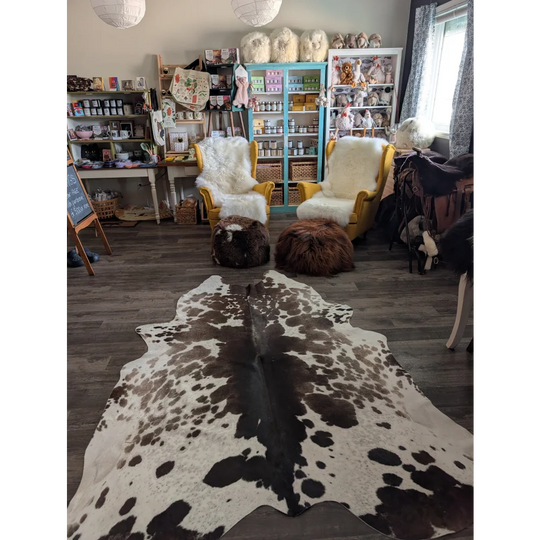 Greymix 895 extra large cowhide rug with striking black and white spotted pattern laid out on the floor