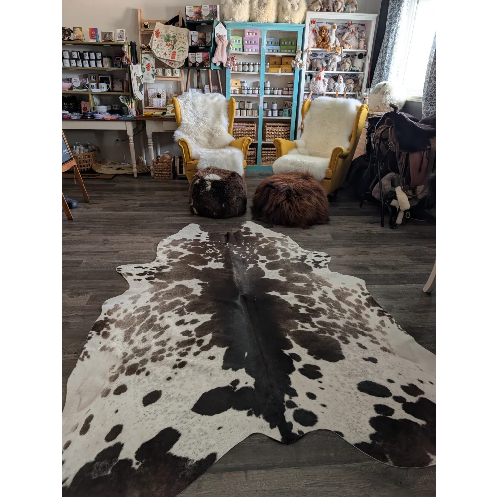 A gorgeous extra large cowhide rug greymix#895 with natural black and white spots measuring 96 by 78 inches