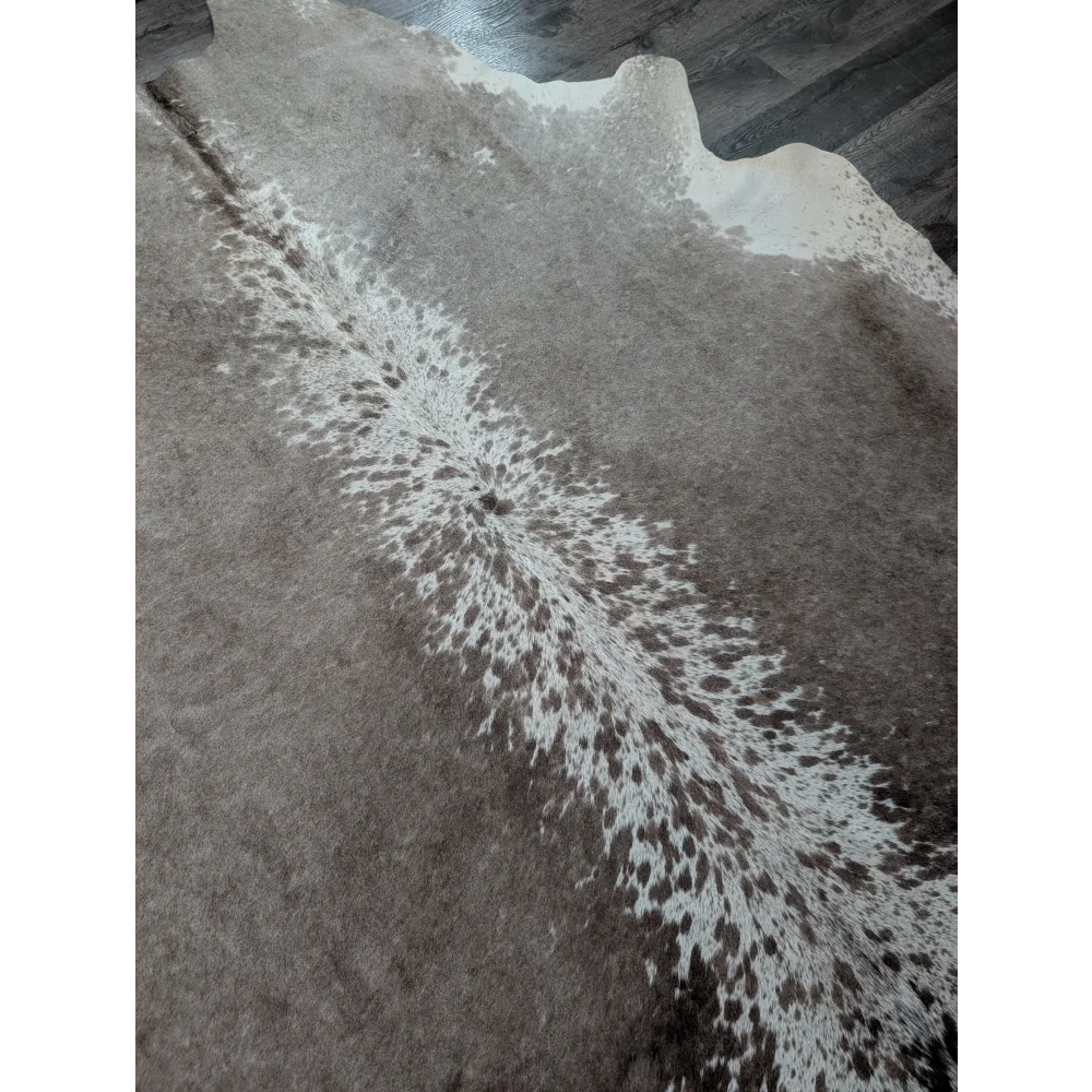 A beautiful extra large gray and white cowhide rug greymix925 with a distinctive spotted pattern perfect for large cowhide decor