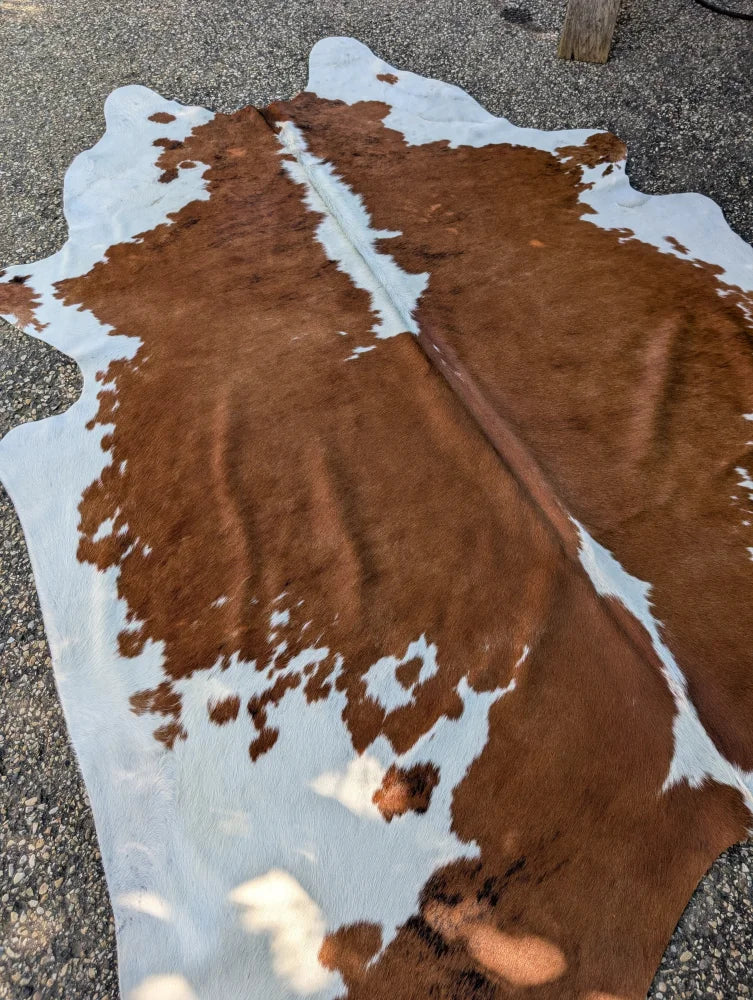 Large brown and white cowhide rug hello1 with unique irregular fur patches perfect for beautiful rugs