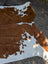 Brown and white large cowhide rug with natural fur texture featuring unique characteristics for beautiful rugs