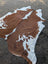 Brown and white large cowhide rug hello1 with natural irregular edges showcasing unique characteristics and beautiful rugs