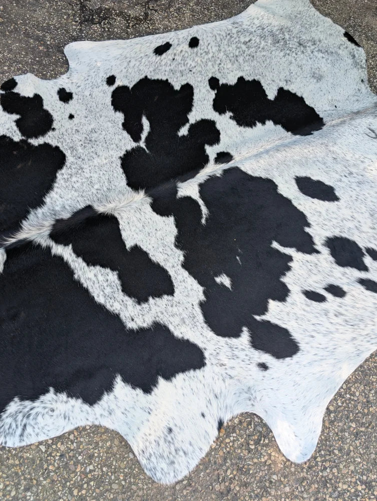 Hello10 large cowhide rug in black and white with unique natural patches adding rustic charm to any space