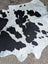Hello10 large cowhide rug in black and white with unique natural patches adding rustic charm to any space