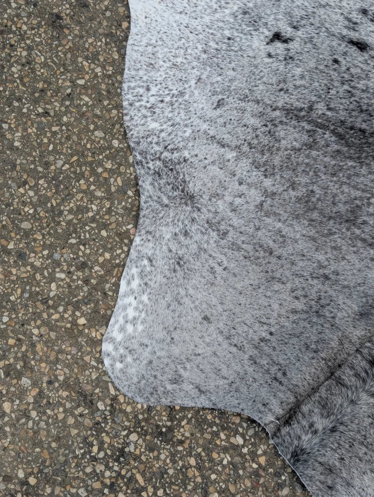 Large gray and black speckled cowhide rug 87 x 72 with soft natural texture and unique characteristics for beautiful rugs