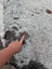Hello11 large cowhide rug with beautiful white and black spots and unique dark brown patch being pointed at