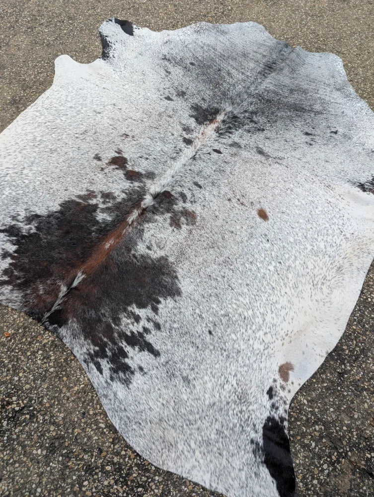 Hello 11 large cowhide rug with white and black natural irregular patches showcasing unique characteristics
