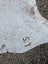 Large cowhide rug with natural brown speckles and us stamp showcasing unique characteristics for beautiful rugs