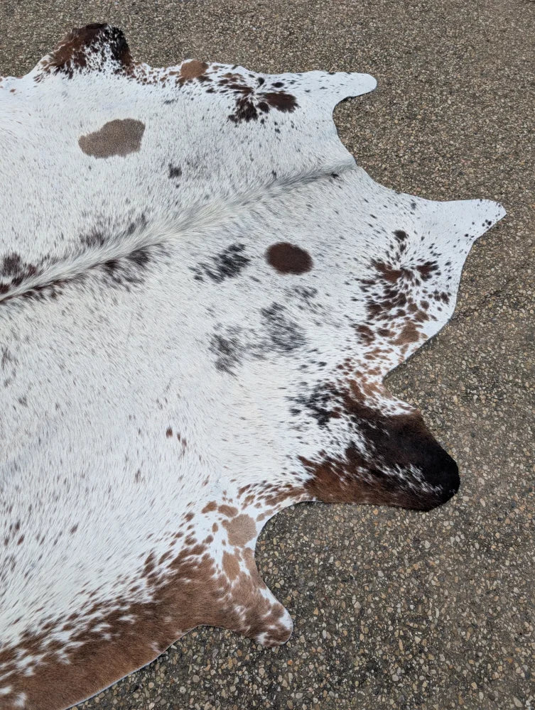 Hello15 large cowhide rug with natural white and brown colors featuring unique dark brown spot patterns
