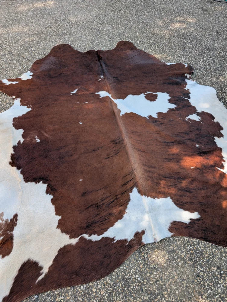 Hello3 large cowhide rug with brown and white natural patches adds unique characteristics and rustic charm to any space