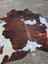 Hello3 large cowhide rug with brown and white natural patches adds unique characteristics and rustic charm to any space