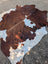 Hello#3 large cowhide rug with brown and white natural patches showcasing unique characteristics and rustic charm