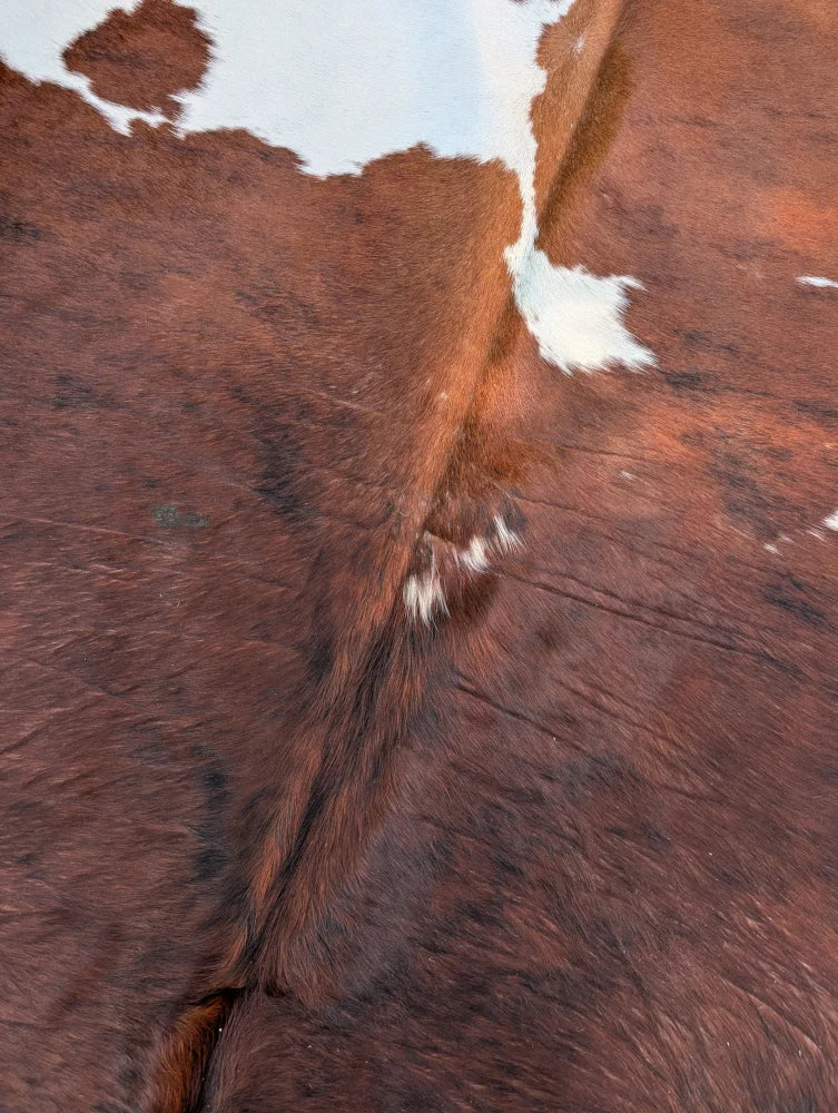 Hello3 large cowhide rug with brown and white natural fur texture showcasing unique characteristics and rustic charm