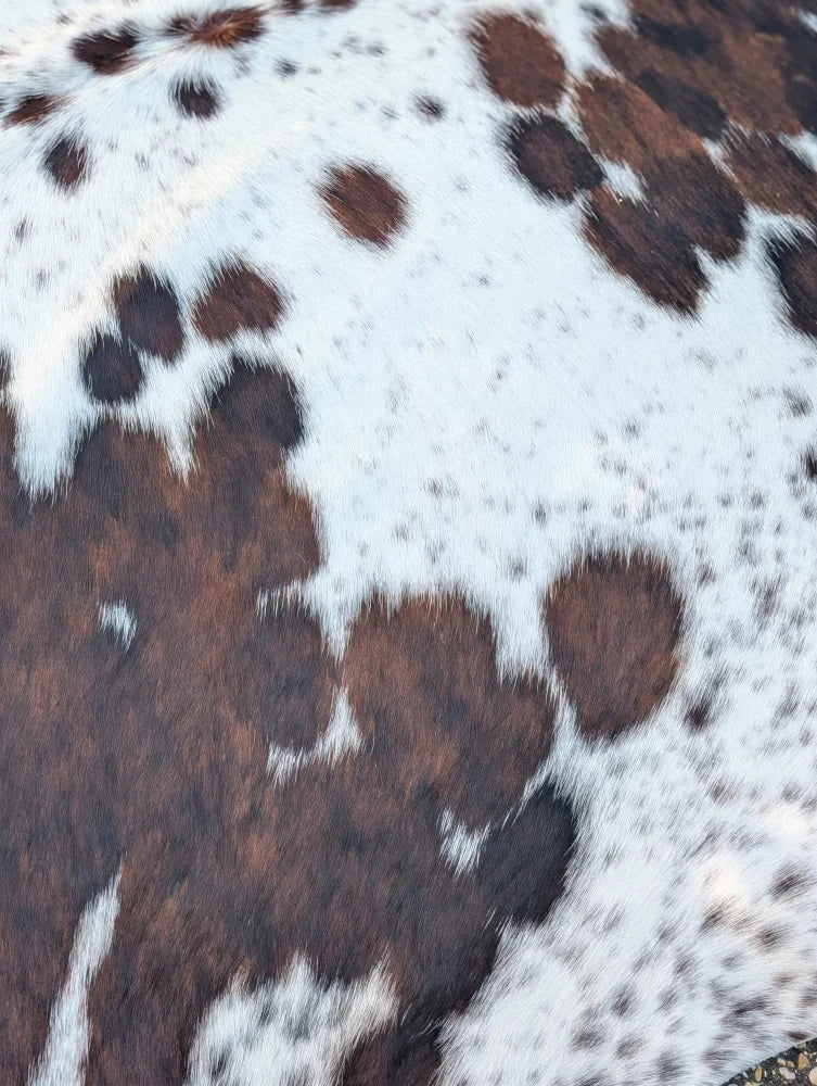 Hello4 large brown and white spotted cowhide rug with natural textured surface and unique rustic charm