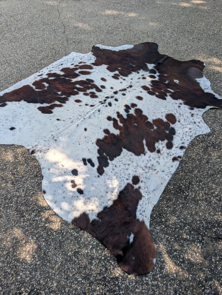 Hello4 large cowhide rug with brown and white natural patches adds rustic charm and unique characteristics to any space