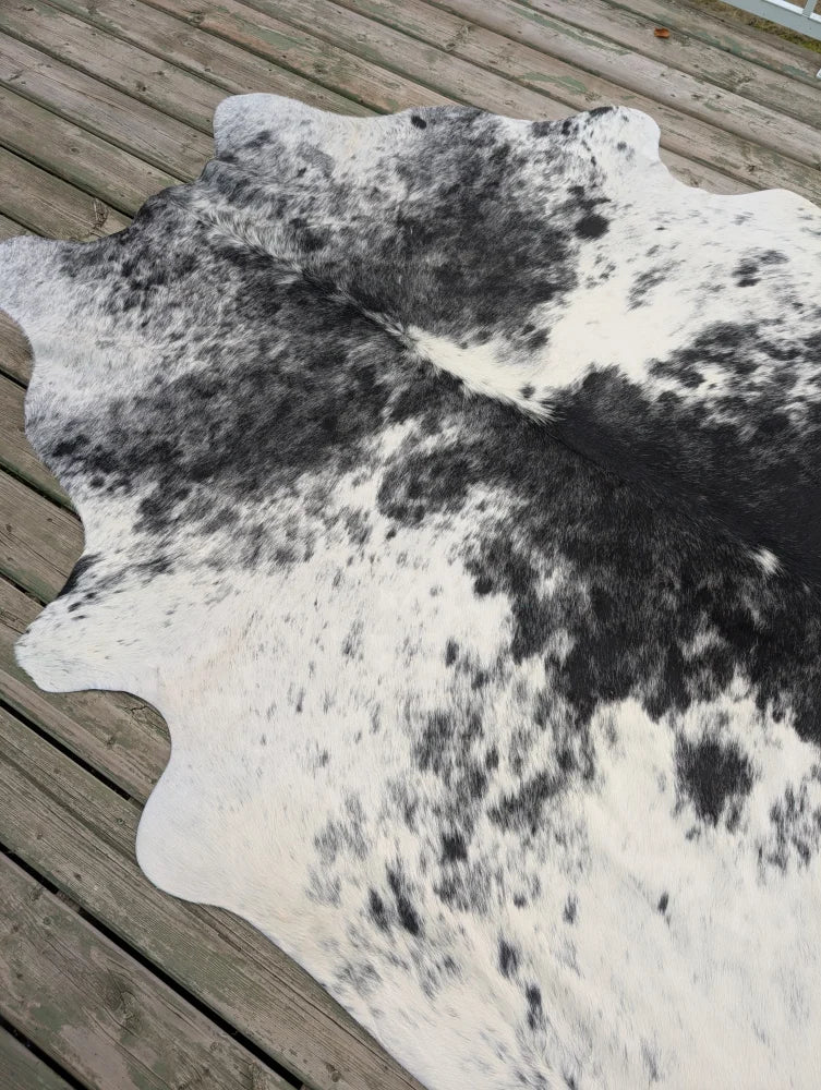 Large black and white cowhide rug with unique natural irregular edges perfect for beautiful rugs collection