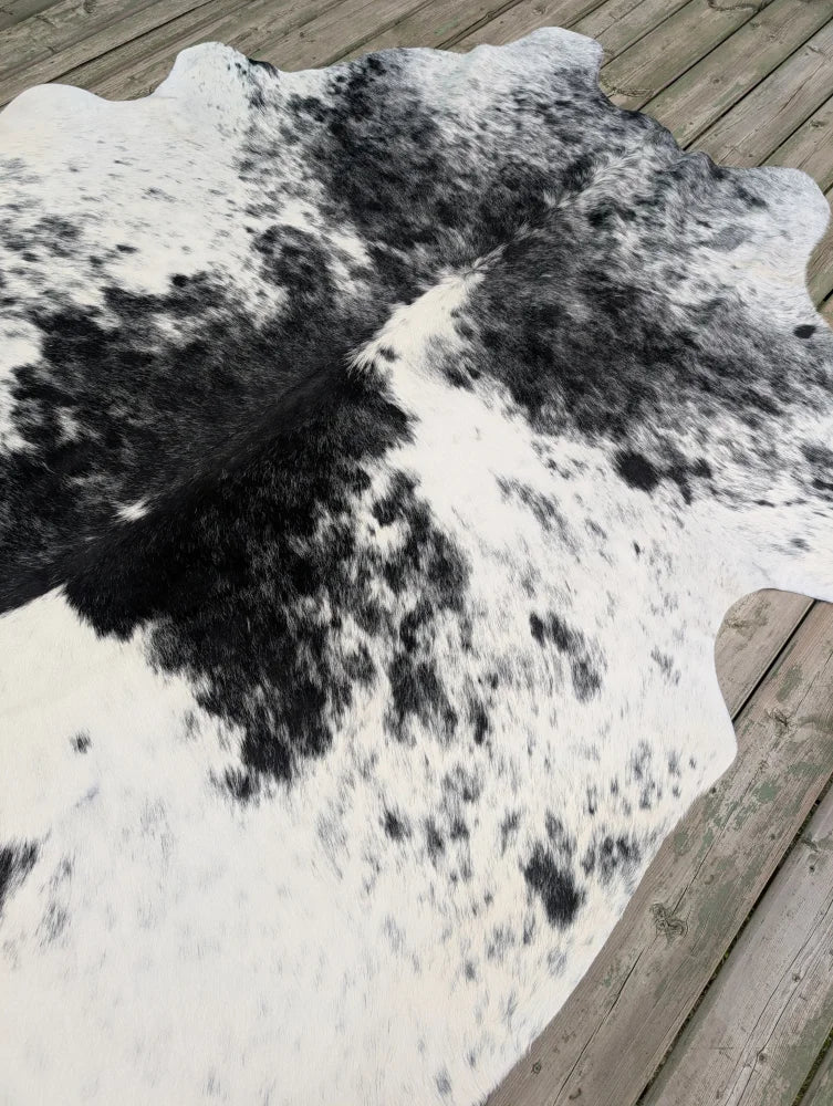 Hello6 large black and white cowhide rug with natural irregular edge featuring unique characteristics and beautiful rugs style