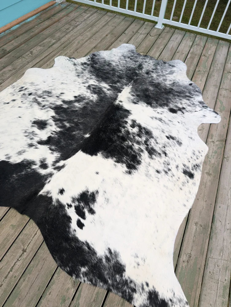 Hello6 large black and white cowhide rug with natural irregular edges showcasing unique characteristics for beautiful rugs