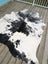 Hello6 large black and white cowhide rug with natural irregular edges showcasing unique characteristics for beautiful rugs