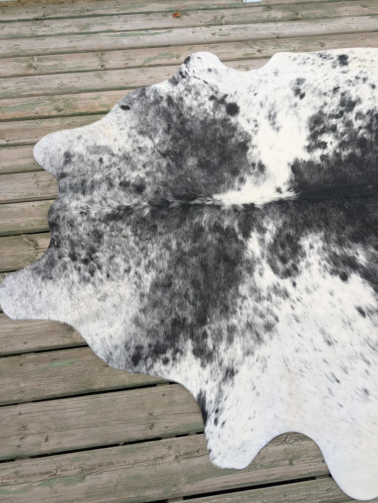 Hello6 large black and white cowhide rug with unique characteristics and a natural irregular shape perfect for beautiful rugs