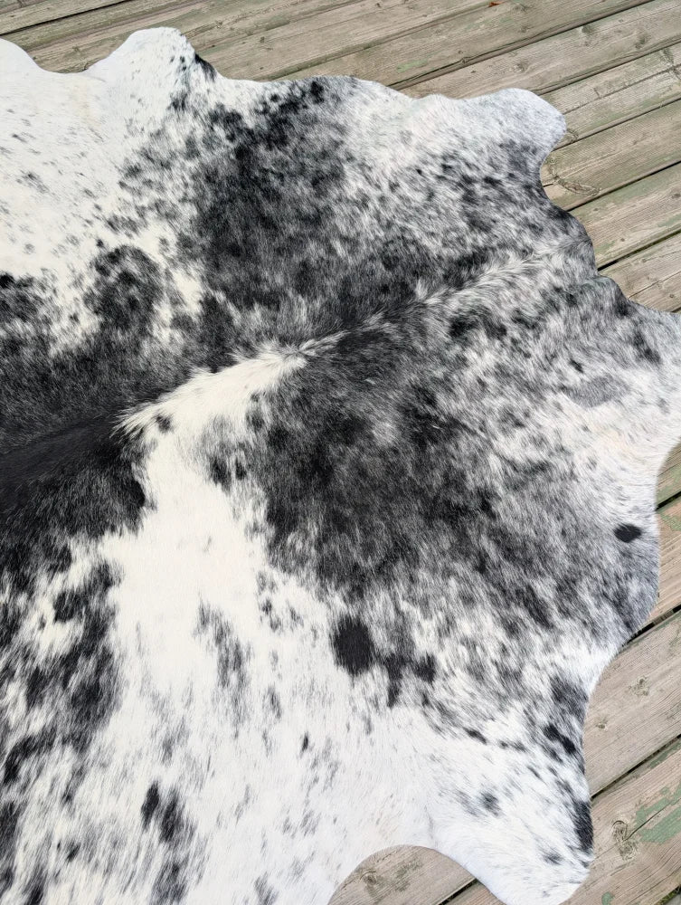 Hello6 large black and white cowhide rug with natural irregular edge showcasing unique characteristics for beautiful rugs