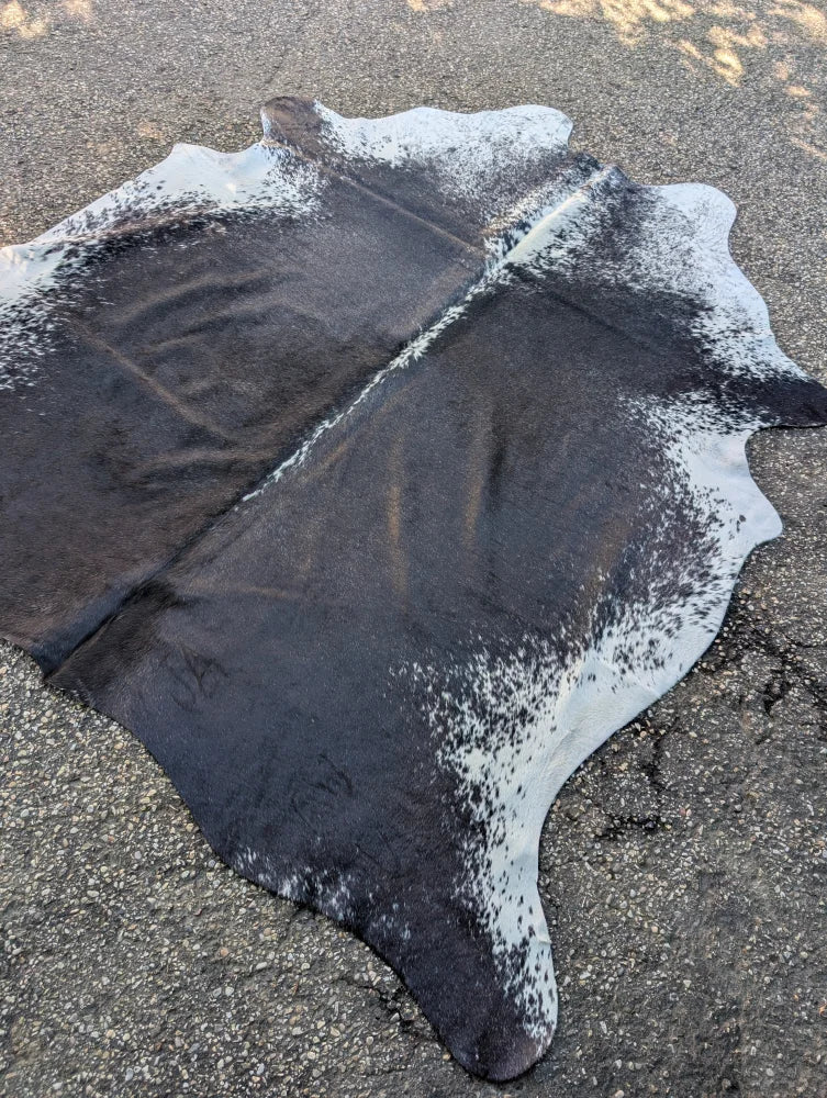 Hello#9 large black and white cowhide rug with unique characteristics and rustic charm featuring a natural edge