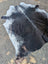 Large black and white cowhide rug with rustic charm and unique characteristics featuring natural irregular edges