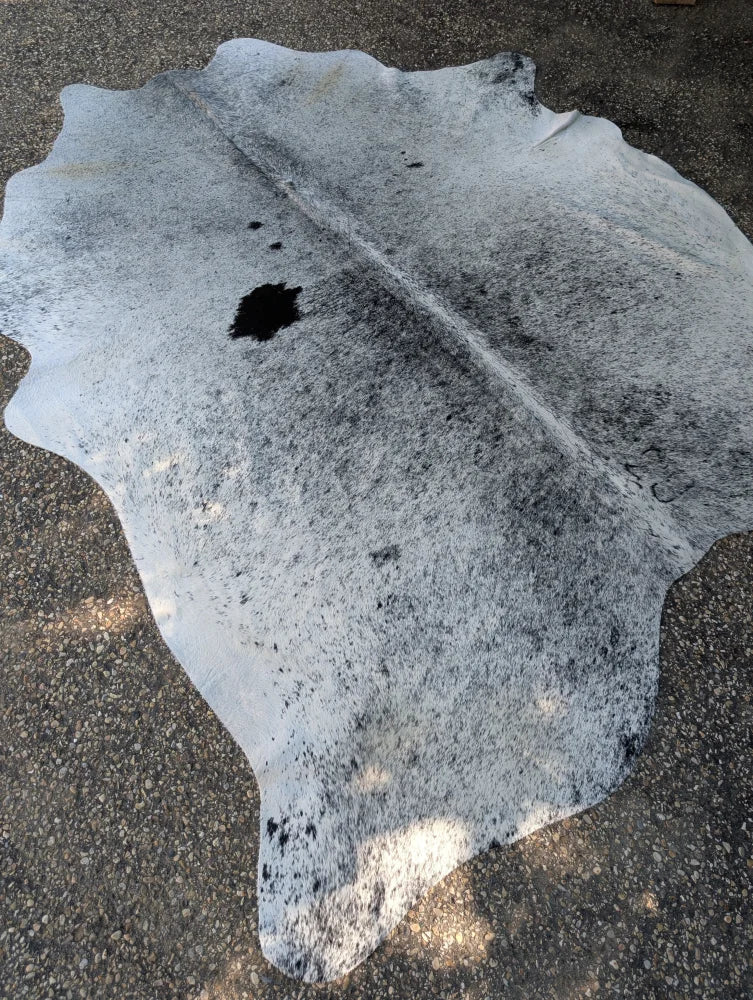 Hellow#7 large gray and black cowhide rug with unique characteristics and rustic charm in an irregular shape