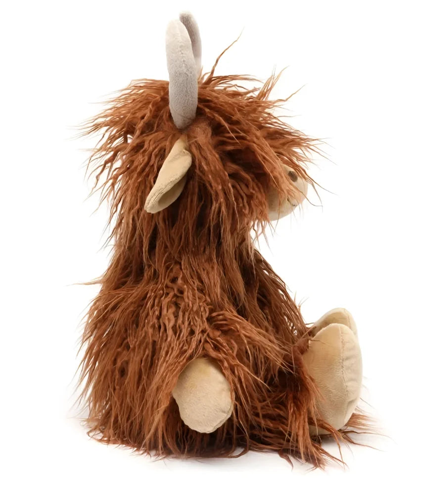 A plush henry the highland cow toy with long shaggy brown fur and light beige hooves and horns