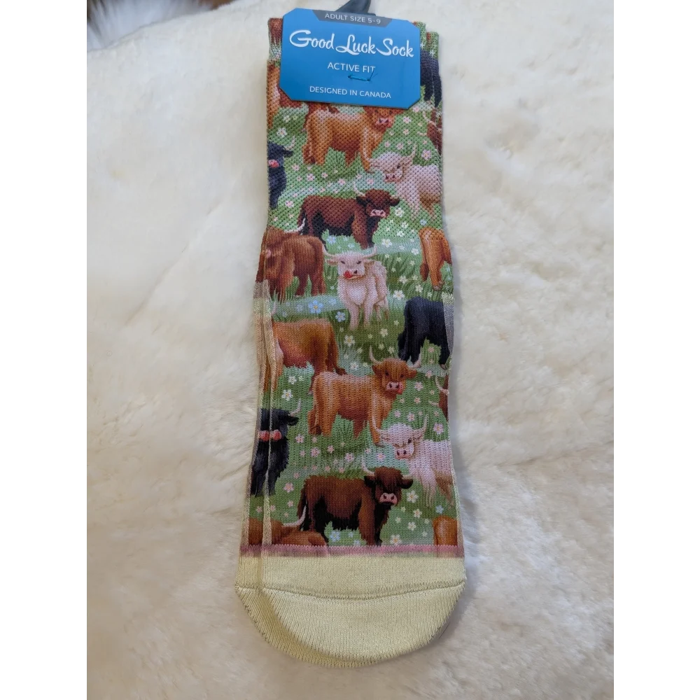 Green and white highland cow print socks by Good Luck Socks with yellow toe and heel