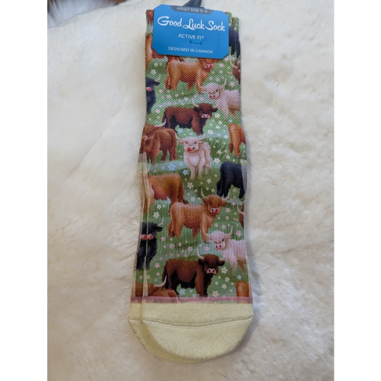 Green and white highland cow print socks by Good Luck Socks with yellow toe and heel