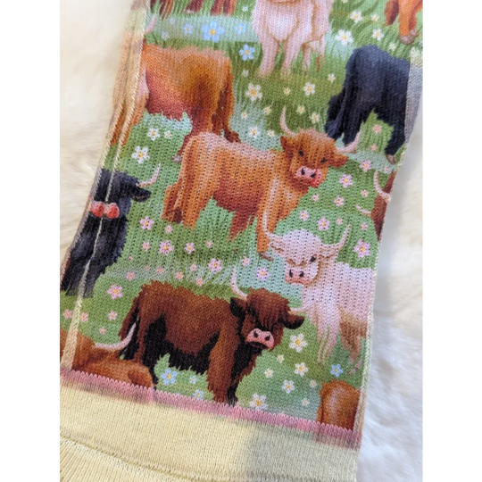 Highland cow socks by Good Luck Socks on green background