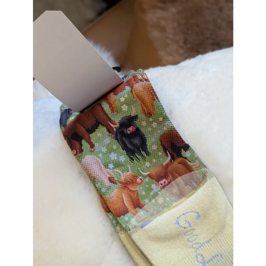 Highland Cow good luck socks napkin with green brown fabric and good text