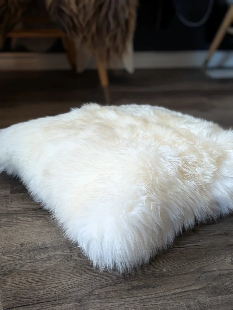 Comfy cream sheepskin pet bed with fluffy Canadian sheep’s wool