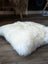 Comfy cream sheepskin pet bed with fluffy Canadian sheep’s wool