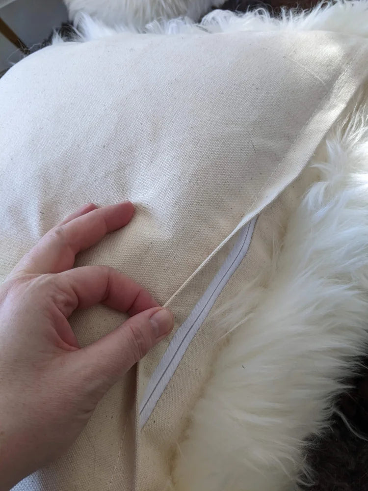 Cream-colored faux fur throw with Canadian sheep’s wool pet bed